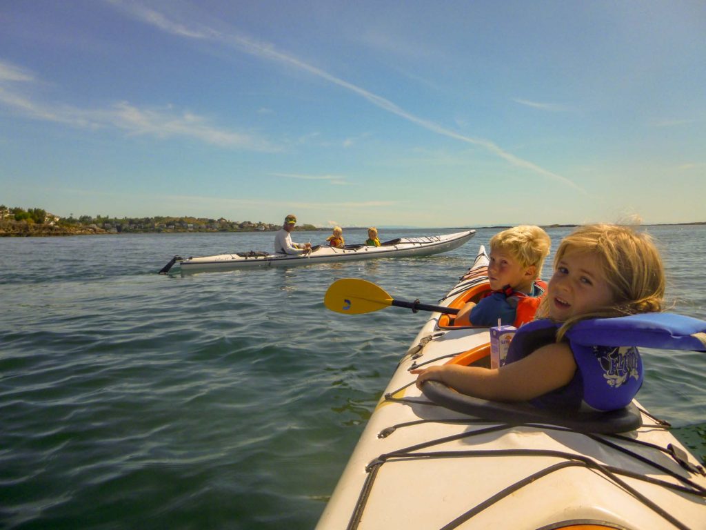 Adults and Kids on family kayak tour on double kayaks